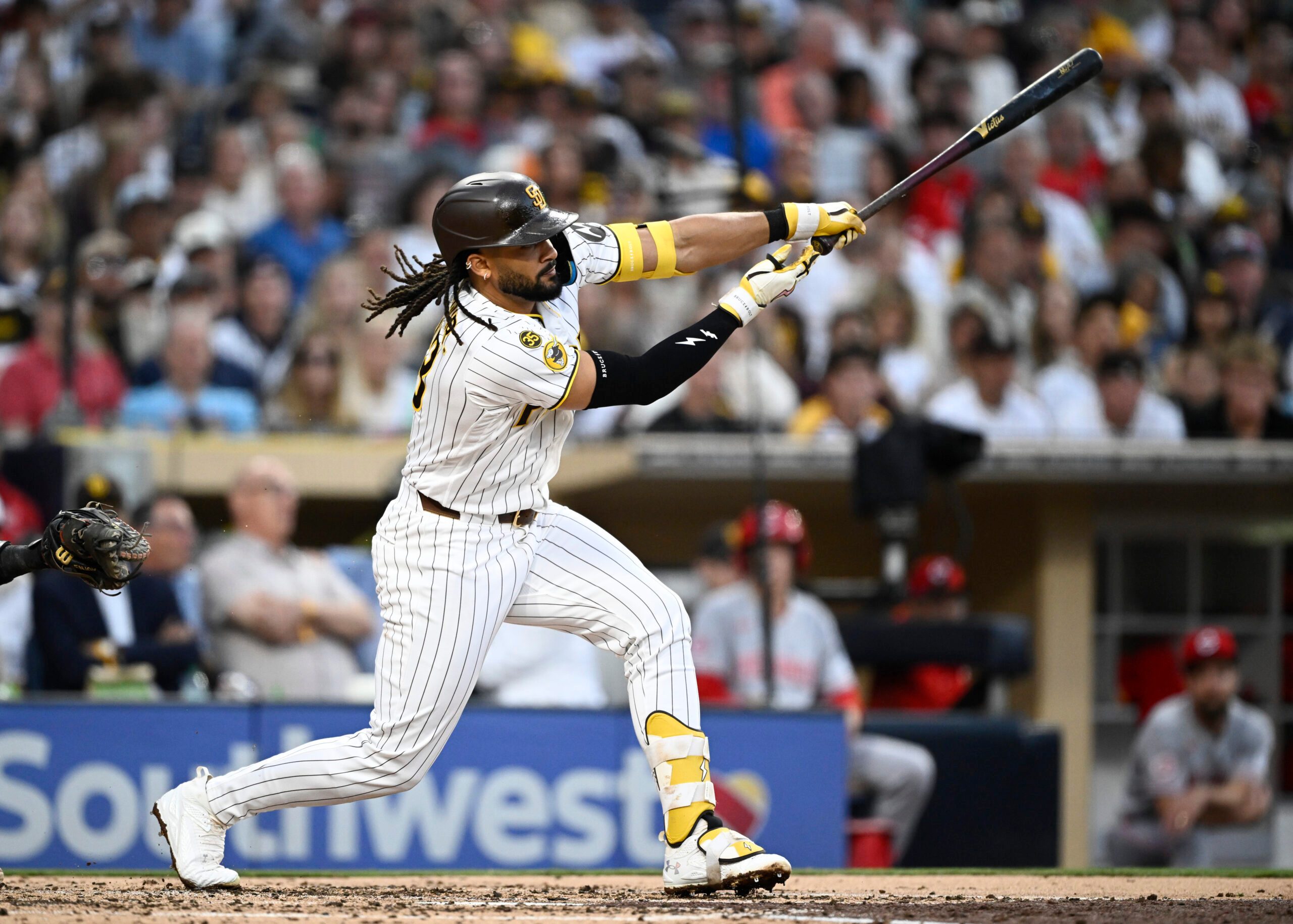 Jun 9, 2026; San Diego, California, USA; San Diego Padres second baseman Fernando Tatis Jr. (23) hits a single during the third inning against the Cincinnati Reds at Petco Park. Mandatory Credit: Denis Poroy-Imagn Images