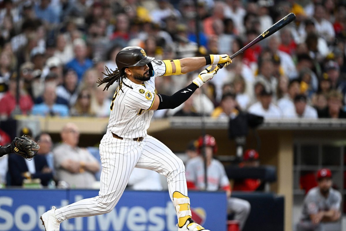 Jun 9, 2026; San Diego, California, USA; San Diego Padres second baseman Fernando Tatis Jr. (23) hits a single during the third inning against the Cincinnati Reds at Petco Park. Mandatory Credit: Denis Poroy-Imagn Images