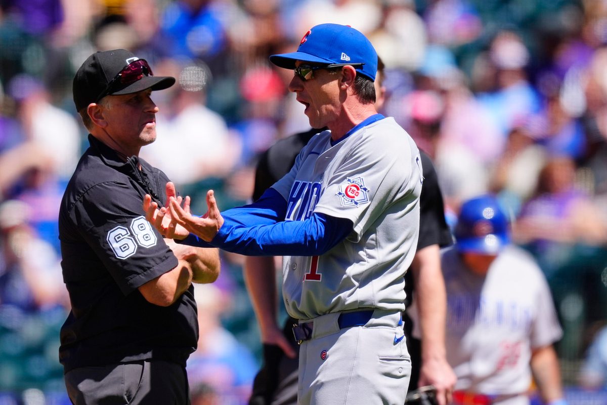 Jun 11, 2026; Denver, Colorado, USA; MLB second base umpire Chris Guccione (68) listens to Chicago Cubs manager Craig Counsell (11) in the sixth inning against the Colorado Rockiesat Coors Field. Mandatory Credit: Ron Chenoy-Imagn Images