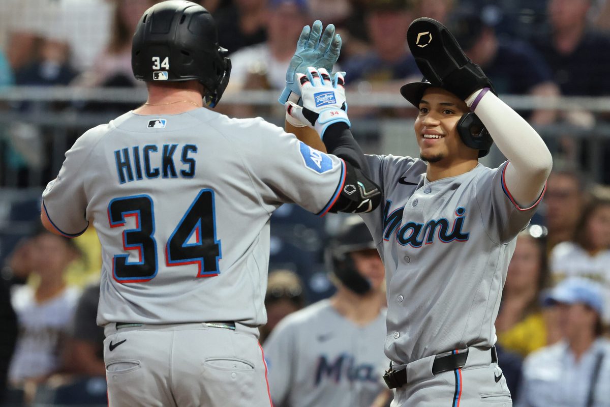 Jun 12, 2026; Pittsburgh, Pennsylvania, USA; Miami Marlins third baseman Javier Sanoja (right) greets designated hitter Liam Hicks (34) crossing home plate on a two run home run against the Pittsburgh Pirates during the eighth inning at PNC Park. Mandatory Credit: Charles LeClaire-Imagn Images