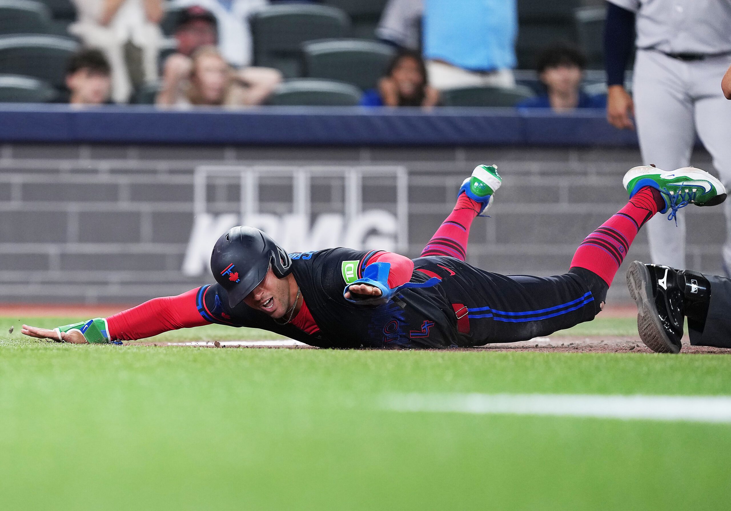 Jun 12, 2026; Toronto, Ontario, CAN; Toronto Blue Jays designated hitter George Springer (4) slides into home safe against the New York Yankees during the eighth inning at Rogers Centre. Mandatory Credit: Nick Turchiaro-Imagn Images