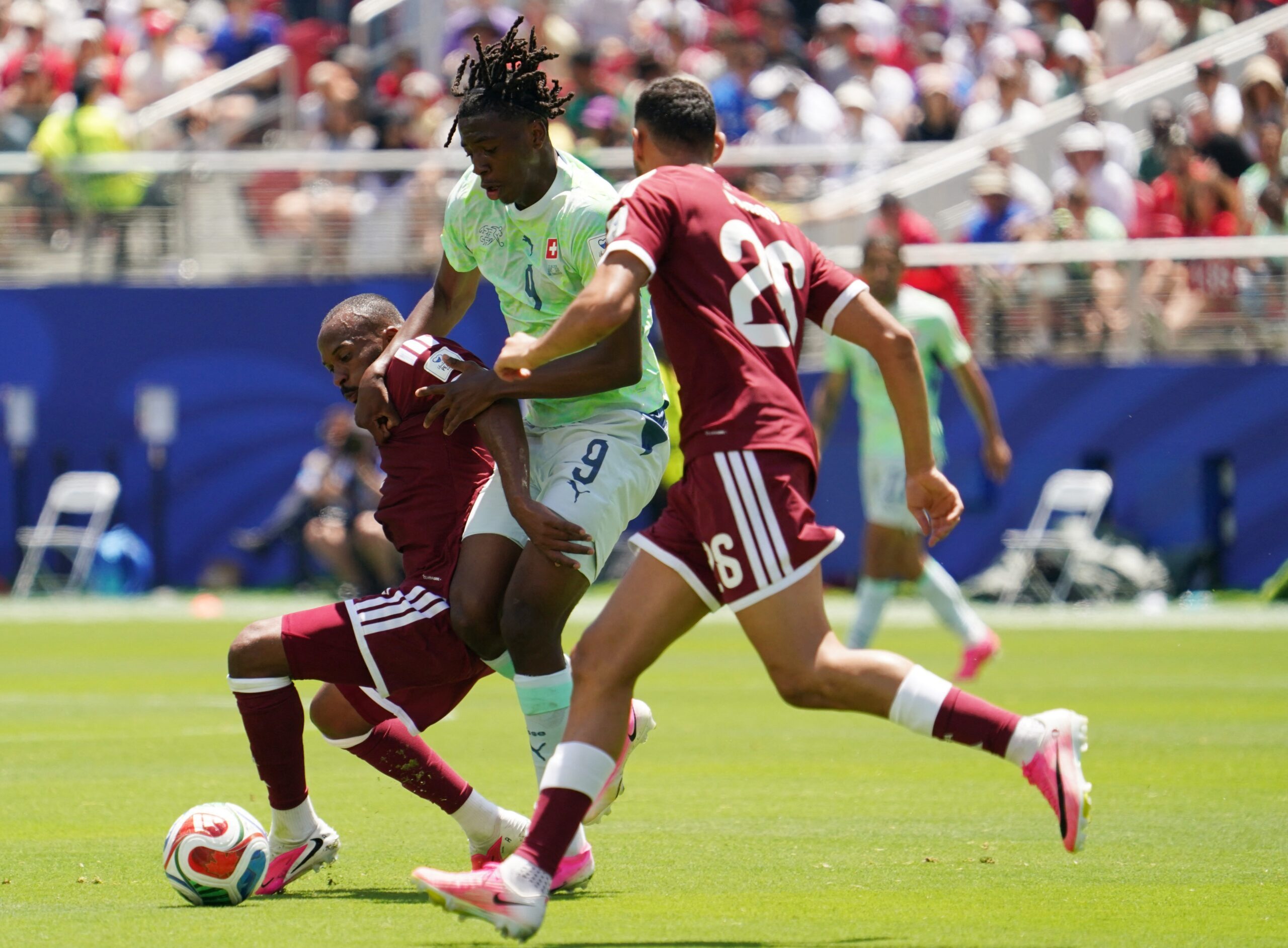 June 13, 2026; Santa Clara, California, U.S.; Switzerland's Johan Manzambi in action with Qatar's Mohamed Manai and Ahmed Fathy.  Mandatory Credit: David Gonzales-Imagn Images