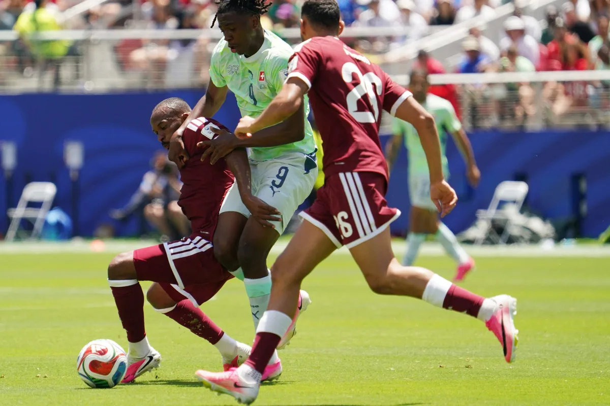 June 13, 2026; Santa Clara, California, U.S.; Switzerland's Johan Manzambi in action with Qatar's Mohamed Manai and Ahmed Fathy. Mandatory Credit: David Gonzales-Imagn Images