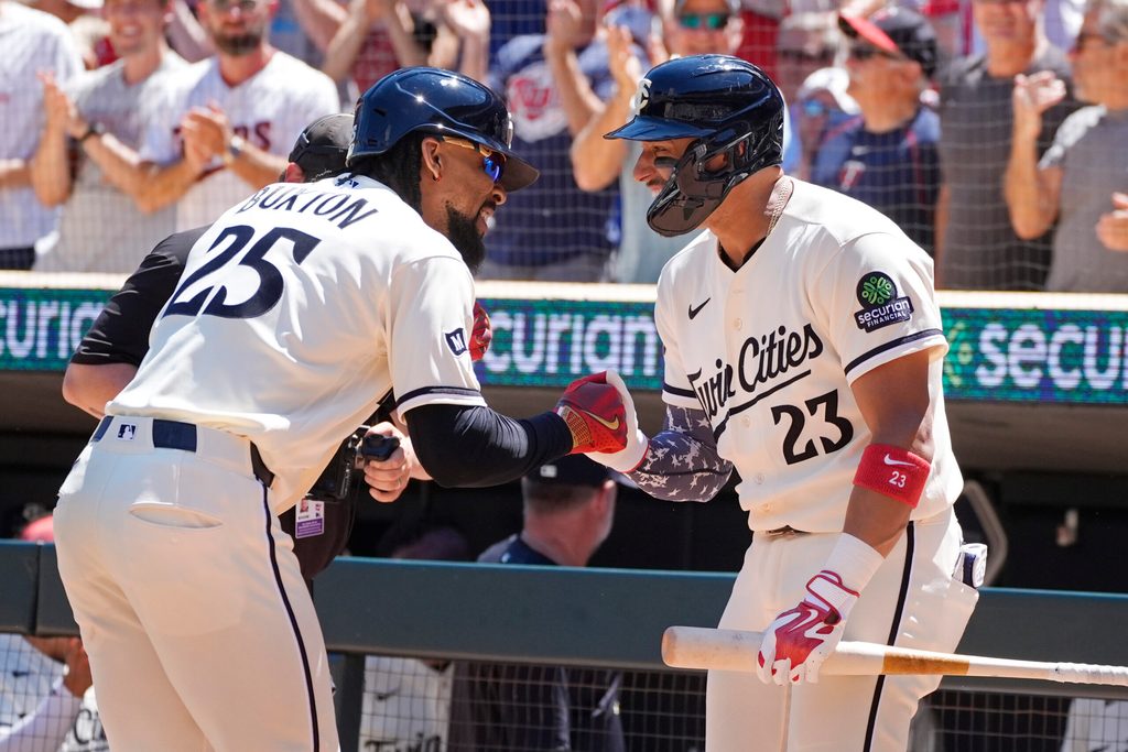 Jun 13, 2026; Minneapolis, Minnesota, USA; Minnesota Twins designated hitter Byron Buxton (25) celebrates his solo home run against the St. Louis Cardinals with first baseman Royce Lewis (23) in the fourth inning at Target Field. Mandatory Credit: Bruce Kluckhohn-Imagn Images