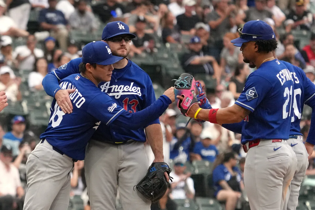 Jun 13, 2026; Chicago, Illinois, USA; Los Angeles Dodgers pitcher Yoshinobu Yamamoto (18) and third baseman Max Muncy (13) hug after Yamamoto leaves the game against the Chicago White Sox during the ninth inning at Rate Field. Mandatory Credit: David Banks-Imagn Images