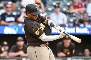 Jun 13, 2026; Baltimore, Maryland, USA;  San Diego Padres third baseman Manny Machado (13) hits a solo home run during the ninth inning against the Baltimore Orioles at Oriole Park at Camden Yards. Mandatory Credit: James A. Pittman-Imagn Images