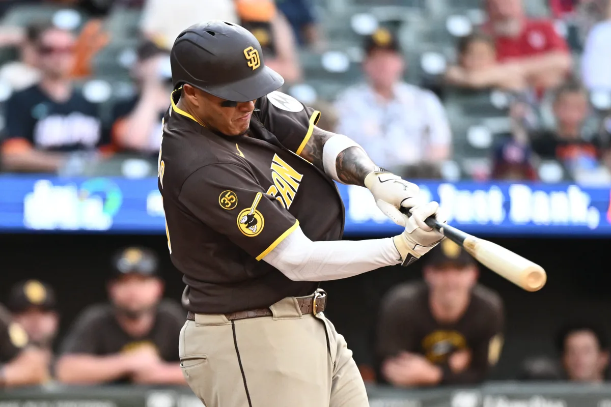 Jun 13, 2026; Baltimore, Maryland, USA; San Diego Padres third baseman Manny Machado (13) hits a solo home run during the ninth inning against the Baltimore Orioles at Oriole Park at Camden Yards. Mandatory Credit: James A. Pittman-Imagn Images