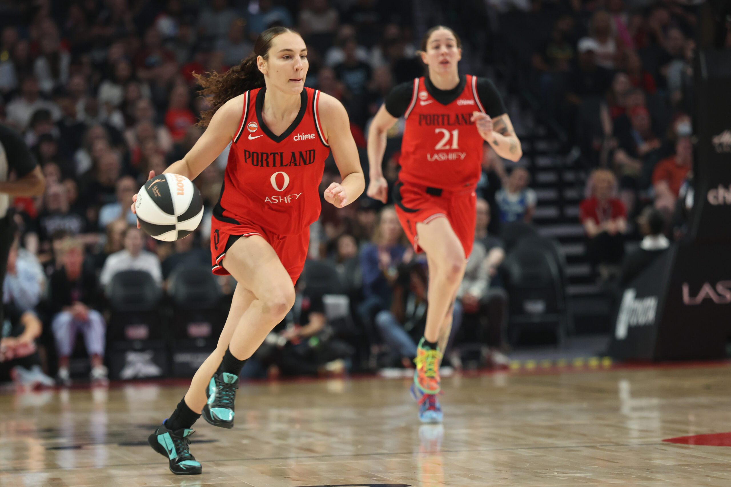 Jun 13, 2026; Portland, Oregon, USA;  Portland Fire guard Carla Leite (0) brings the ball up the court as forward Emily Engstler (21) follows during the first half against the Dallas Wings at Moda Center. Mandatory Credit: Jaime Valdez-Imagn Images