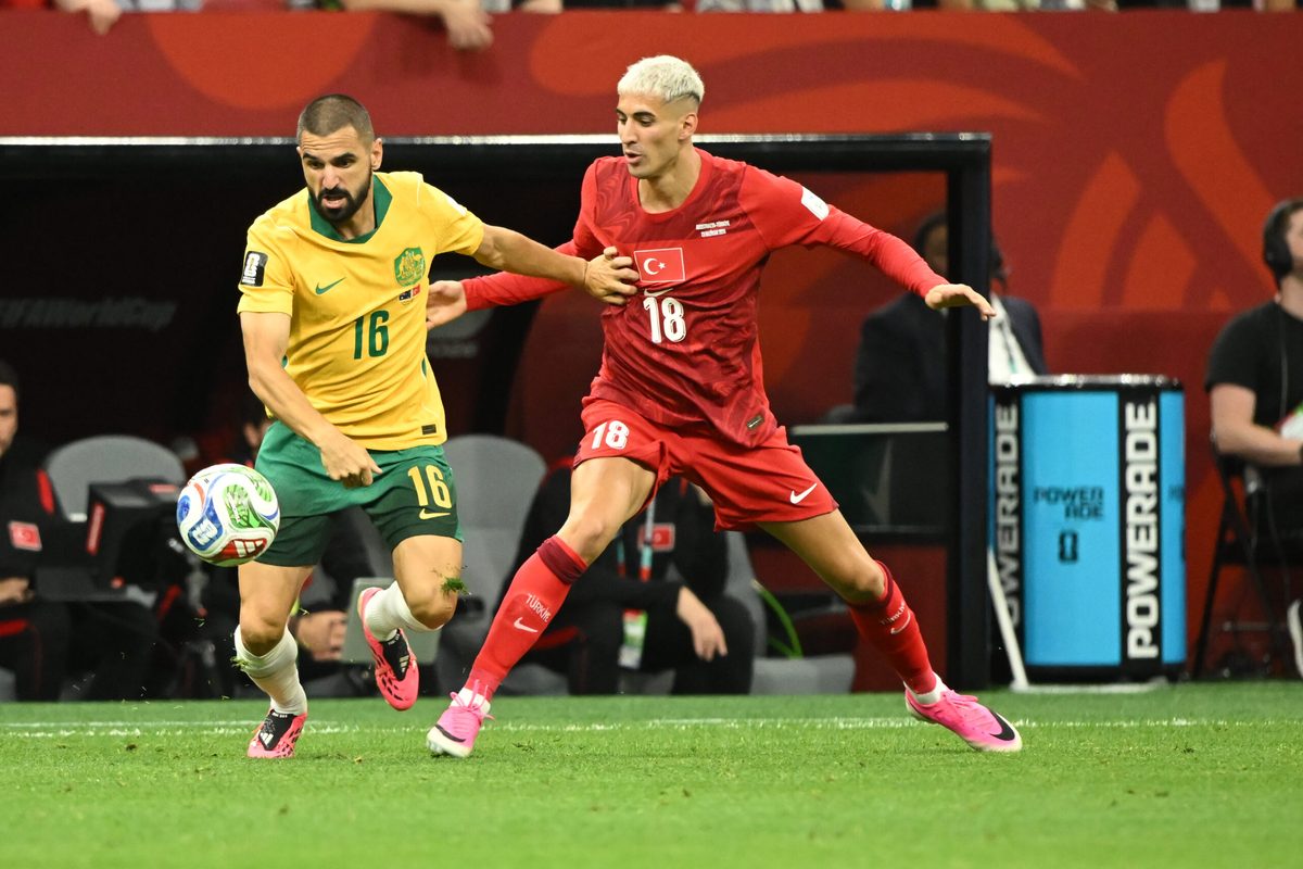 Jun 13, 2026; Vancouver, British Columbia, USA; Australia defender Aziz Behich (16) battles for the ball against Turkiye defender Mert Muldur (18) during the second half during a Group D match in the 2026 FIFA World Cup at BC Place Vancouver. Mandatory Credit: Anne-Marie Sorvin-Imagn Images