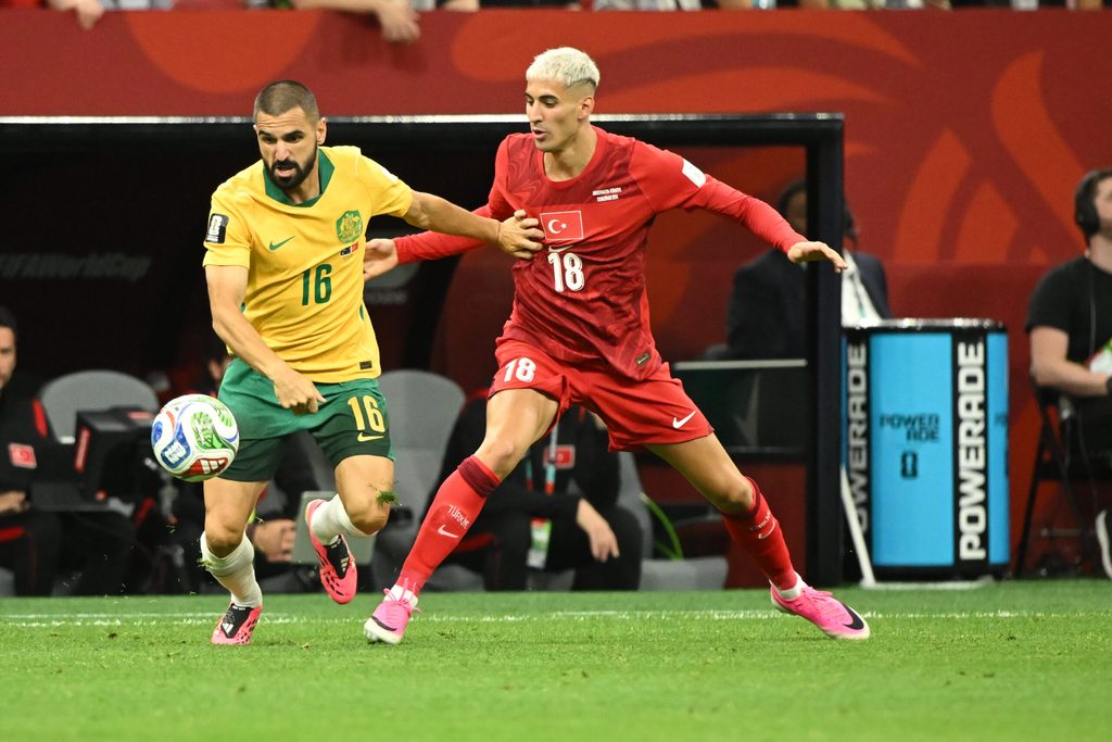 Jun 13, 2026; Vancouver, British Columbia, USA; Australia defender Aziz Behich (16) battles for the ball against Turkiye defender Mert Muldur (18) during the second half during a Group D match in the 2026 FIFA World Cup at BC Place Vancouver. Mandatory Credit: Anne-Marie Sorvin-Imagn Images