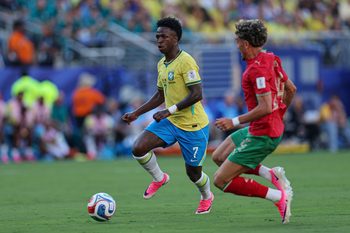 Jun 13, 2026; East Rutherford, New Jersey, USA; Brazil forward Vinicius Junior (7) controls the ball in front of Morocco midfielder Neil El Aynaoui (24) during a Group C match of the 2026 FIFA World Cup at New York New Jersey Stadium. Mandatory Credit: Vincent Carchietta-Imagn Images
