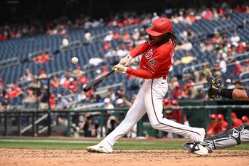Jun 14, 2026; Washington, District of Columbia, USA; Washington Nationals shortstop CJ Abrams (5) hits the ball into play against the Seattle Mariners during the eighth inning at Nationals Park. Mandatory Credit: Rafael Suanes-Imagn Images