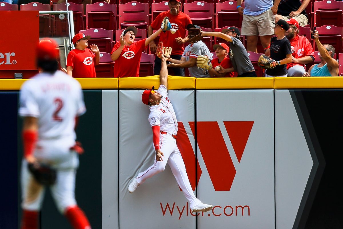 Jun 14, 2026; Cincinnati, Ohio, USA; Cincinnati Reds outfielder Noelvi Marte (4) attempts to catch a solo home run hit by Arizona Diamondbacks catcher Gabriel Moreno (not pictured) in the eighth inning at Great American Ball Park. Mandatory Credit: Katie Stratman-Imagn Images