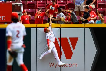Jun 14, 2026; Cincinnati, Ohio, USA; Cincinnati Reds outfielder Noelvi Marte (4) attempts to catch a solo home run hit by Arizona Diamondbacks catcher Gabriel Moreno (not pictured) in the eighth inning at Great American Ball Park. Mandatory Credit: Katie Stratman-Imagn Images