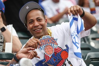 Jun 14, 2026; New York City, New York, USA;  A fan at the game between the Atlanta Braves and New York Mets celebrates the New York Knicks winning the NBA Finals at Citi Field. Mandatory Credit: Wendell Cruz-Imagn Images