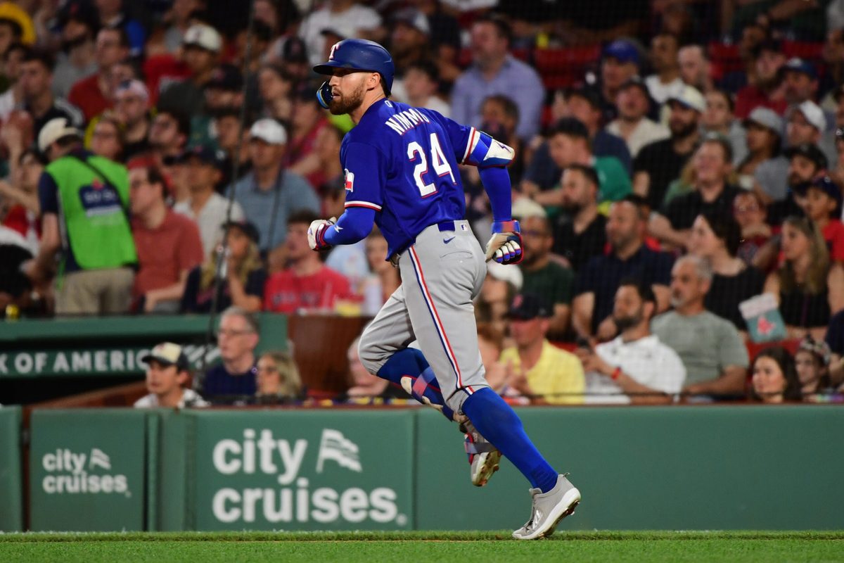 Jun 14, 2026; Boston, Massachusetts, USA;  Texas Rangers right fielder Brandon Nimmo (24) hits an RBI double during the fourth inning against the Boston Red Sox at Fenway Park. Mandatory Credit: Bob DeChiara-Imagn Images