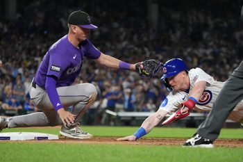Jun 15, 2026; Chicago, Illinois, USA; Chicago Cubs center fielder Pete Crow-Armstrong (4) is tagged out at first base by Colorado Rockies first baseman TJ Rumfield (7) on a pick-off during the seventh inning Wrigley Field. Mandatory Credit: David Banks-Imagn Images