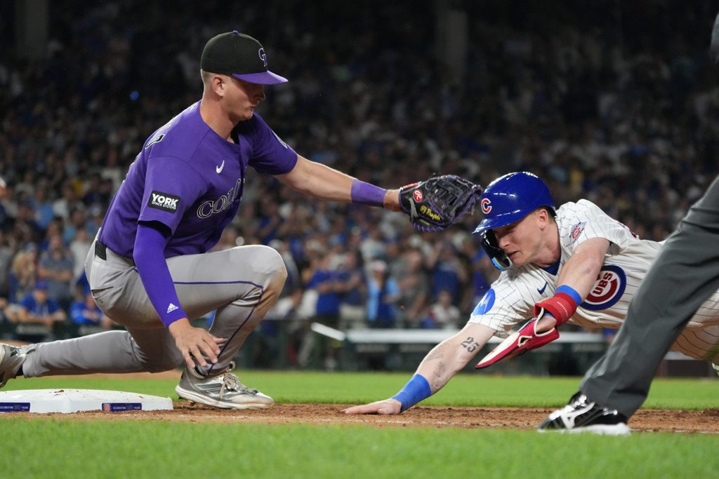 Jun 15, 2026; Chicago, Illinois, USA; Chicago Cubs center fielder Pete Crow-Armstrong (4) is tagged out at first base by Colorado Rockies first baseman TJ Rumfield (7) on a pick-off during the seventh inning Wrigley Field. Mandatory Credit: David Banks-Imagn Images