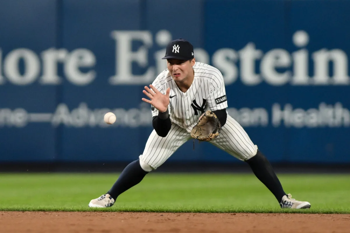 Jun 16, 2026; Bronx, New York, USA; New York Yankees shortstop Anthony Volpe (11) fields a ground ball hit by Chicago White Sox center fielder Luisangel Acuña (not pictured) and throws to first base for an out during the ninth inning at Yankee Stadium. Mandatory Credit: John Jones-Imagn Images