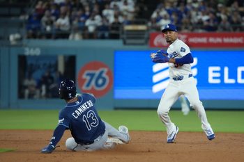 Jun 16, 2026; Los Angeles, California, USA;  Los Angeles Dodgers shortstop Mookie Betts (50) forces out Tampa Bay Rays third baseman Junior Caminero (13) during the seventh inning at Dodger Stadium. Mandatory Credit: Kirby Lee-Imagn Images