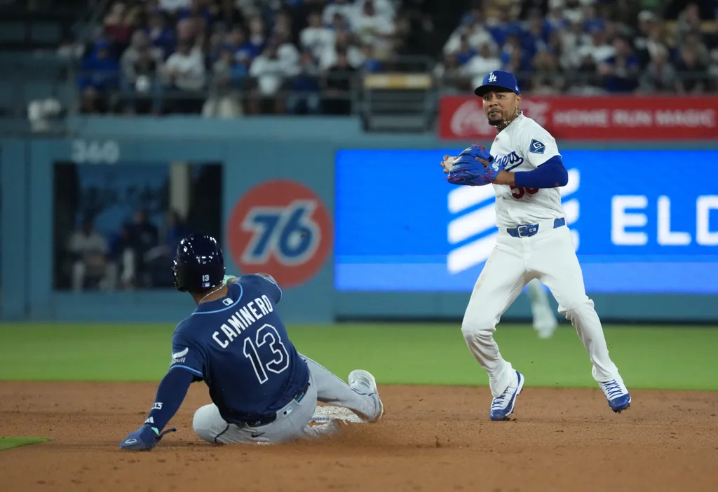 Jun 16, 2026; Los Angeles, California, USA; Los Angeles Dodgers shortstop Mookie Betts (50) forces out Tampa Bay Rays third baseman Junior Caminero (13) during the seventh inning at Dodger Stadium. Mandatory Credit: Kirby Lee-Imagn Images
