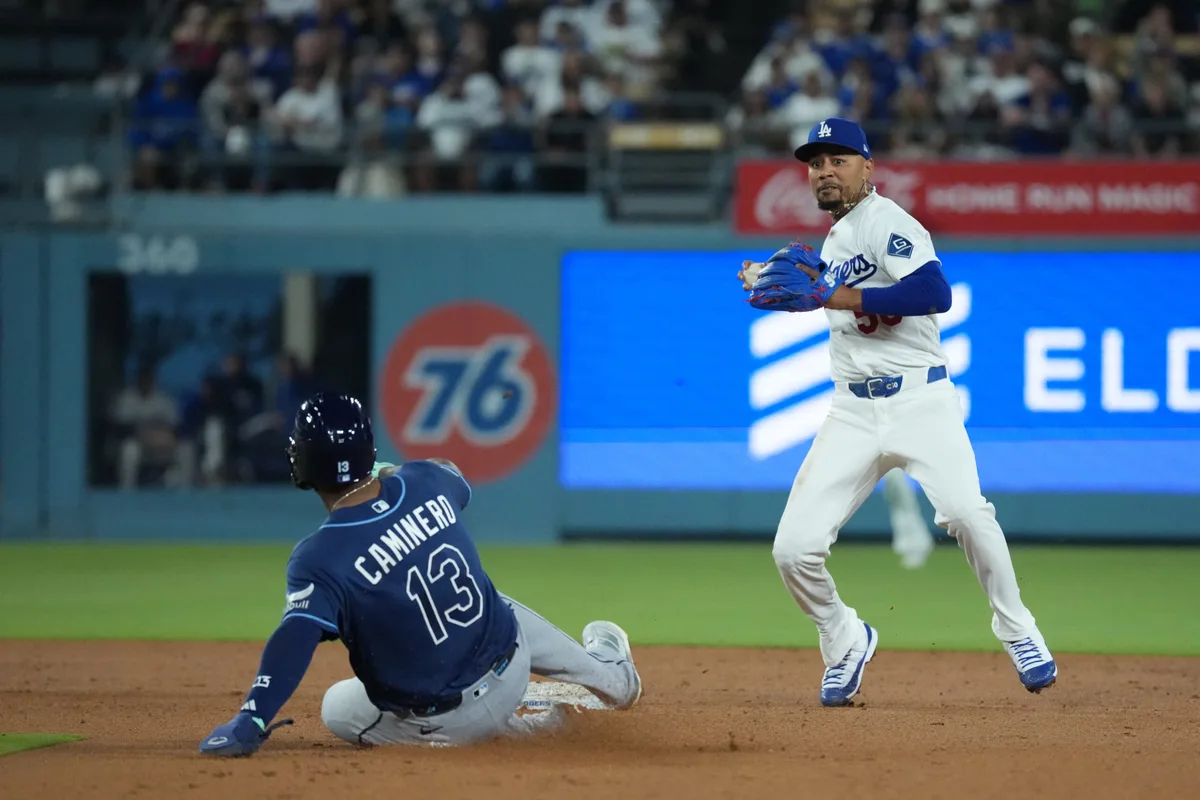 Jun 16, 2026; Los Angeles, California, USA; Los Angeles Dodgers shortstop Mookie Betts (50) forces out Tampa Bay Rays third baseman Junior Caminero (13) during the seventh inning at Dodger Stadium. Mandatory Credit: Kirby Lee-Imagn Images