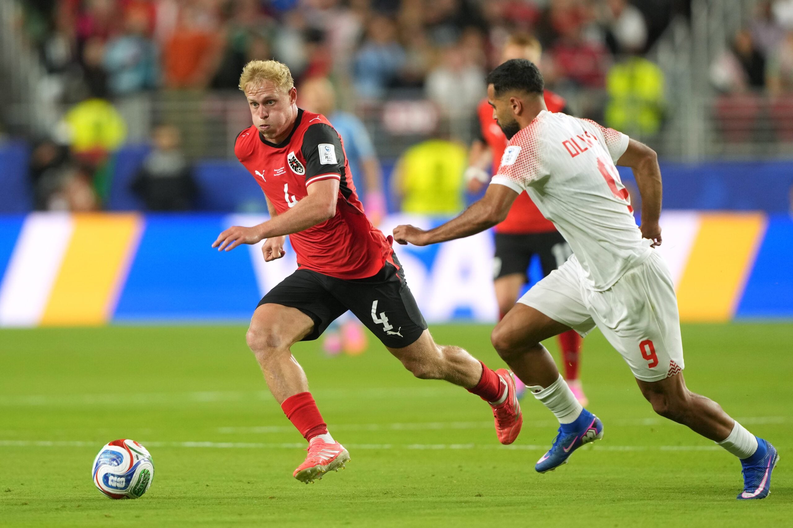 Jun 16, 2026; Santa Clara, California, USA; Austria midfielder Xaver Schlager (4) dribbles against Jordan forward Ali Olwan (9) during a Group J match of the 2026 FIFA World Cup at San Francisco Bay Area Stadium. Mandatory Credit: Darren Yamashita-Imagn Images