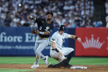 Jun 18, 2026; Bronx, New York, USA;  Chicago White Sox shortstop Luisangel Acuña (0) throws past New York Yankees first baseman Ben Rice (22) attempting to complete a double play in the sixth inning at Yankee Stadium. Mandatory Credit: Wendell Cruz-Imagn Images