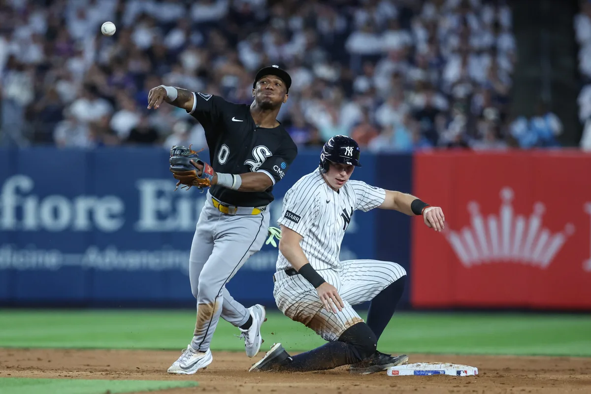 Jun 18, 2026; Bronx, New York, USA; Chicago White Sox shortstop Luisangel Acuña (0) throws past New York Yankees first baseman Ben Rice (22) attempting to complete a double play in the sixth inning at Yankee Stadium. Mandatory Credit: Wendell Cruz-Imagn Images