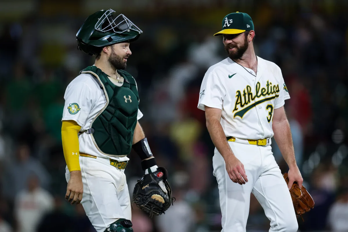 Jun 18, 2026; West Sacramento, California, USA; Athletics catcher Shea Langeliers (23) and pitcher Hogan Harris (36) walk off the field after a game against the Los Angeles Angels at Sutter Health Park. Mandatory Credit: Sergio Estrada-Imagn Images