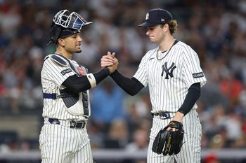 Jun 19, 2026; Bronx, New York, USA; New York Yankees pitcher Cam Schlittler (31) shakes hands with catcher J.C. Escarra (25) after the top of the sixth inning against the Cincinnati Reds at Yankee Stadium. Mandatory Credit: Vincent Carchietta-Imagn Images