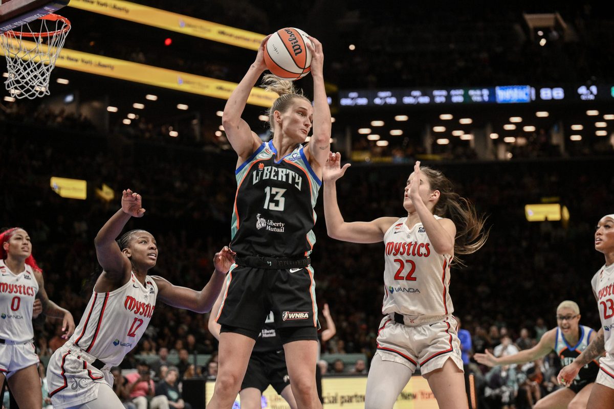 Jun 19, 2026; Brooklyn, New York, USA; New York Liberty forward Leonie Fiebich (13) rebounds the ball as Washington Mystics guard Sonia Citron (22) defends during the second half at Barclays Center. Mandatory Credit: John Jones-Imagn Images