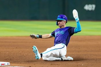 Jun 19, 2026; Phoenix, Arizona, USA; Arizona Diamondbacks outfielder Corbin Carroll slides into third base in the fifth inning against the Minnesota Twins at Chase Field. Mandatory Credit: Mark J. Rebilas-Imagn Images