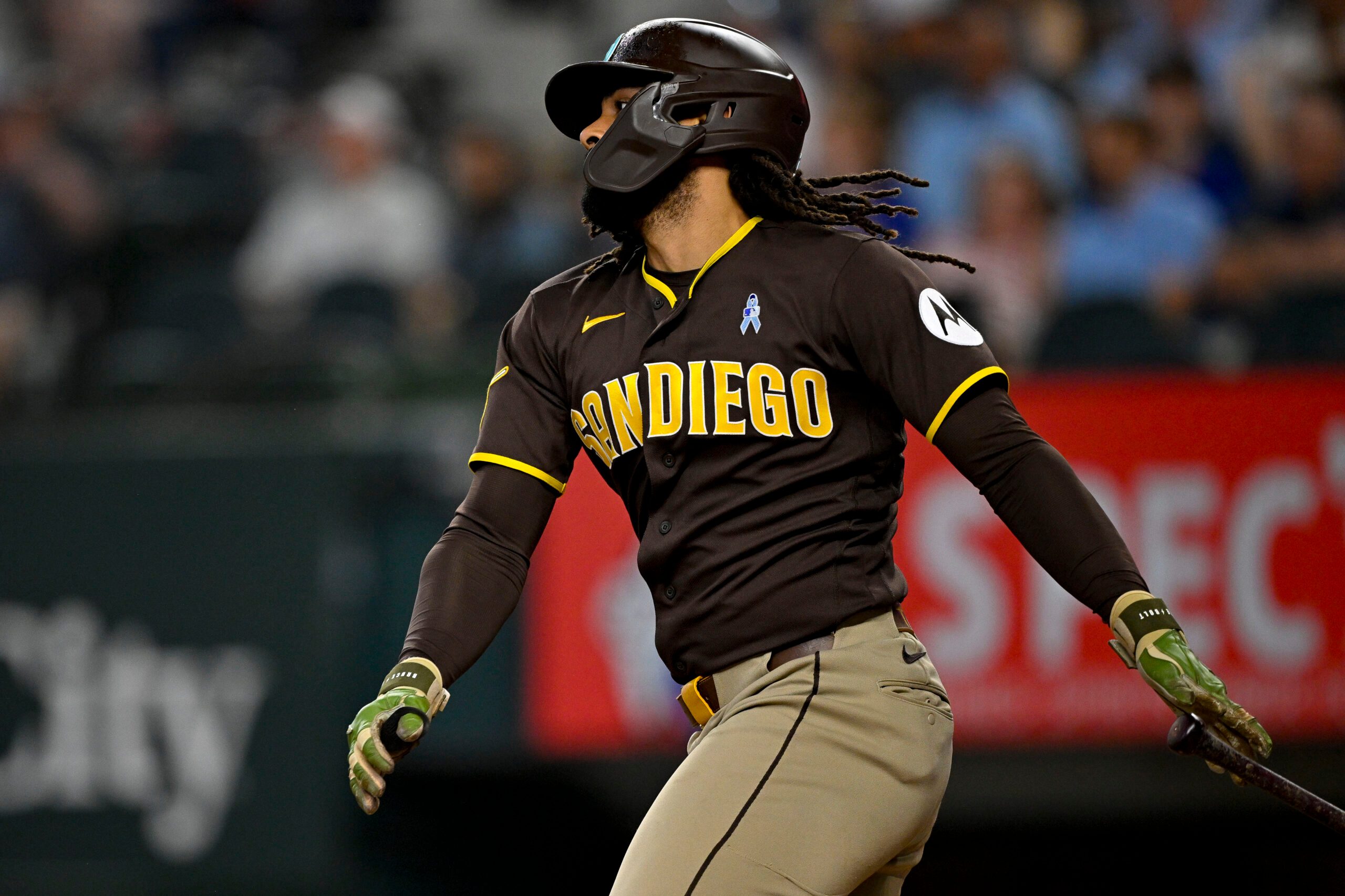 Jun 21, 2026; Arlington, Texas, USA; San Diego Padres pinch hitter Fernando Tatis Jr. (23) hits a single against the Texas Rangers during the ninth inning at Globe Life Field. Mandatory Credit: Jerome Miron-Imagn Images