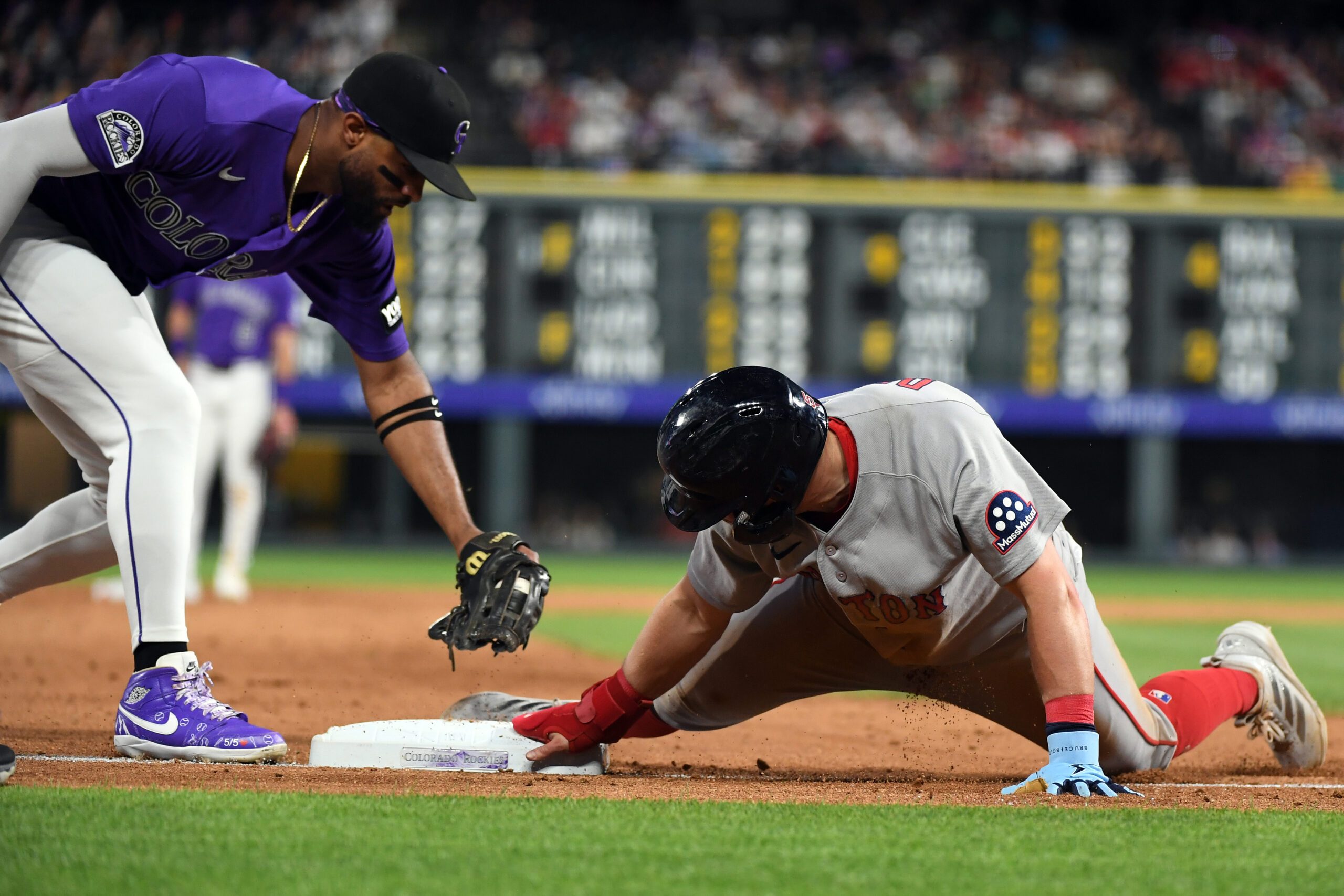 Jun 22, 2026; Denver, Colorado, USA; Boston Red Sox infielder Caleb Durbin (5) slides safely into third base ahead of a tag by Colorado Rockies outfielder Willi Castro (3) in the ninth inning at Coors Field. Mandatory Credit: Christopher Hanewinckel-Imagn Images