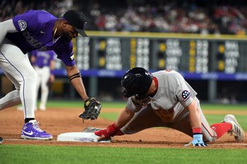 Jun 22, 2026; Denver, Colorado, USA; Boston Red Sox infielder Caleb Durbin (5) slides safely into third base ahead of a tag by Colorado Rockies outfielder Willi Castro (3) in the ninth inning at Coors Field. Mandatory Credit: Christopher Hanewinckel-Imagn Images