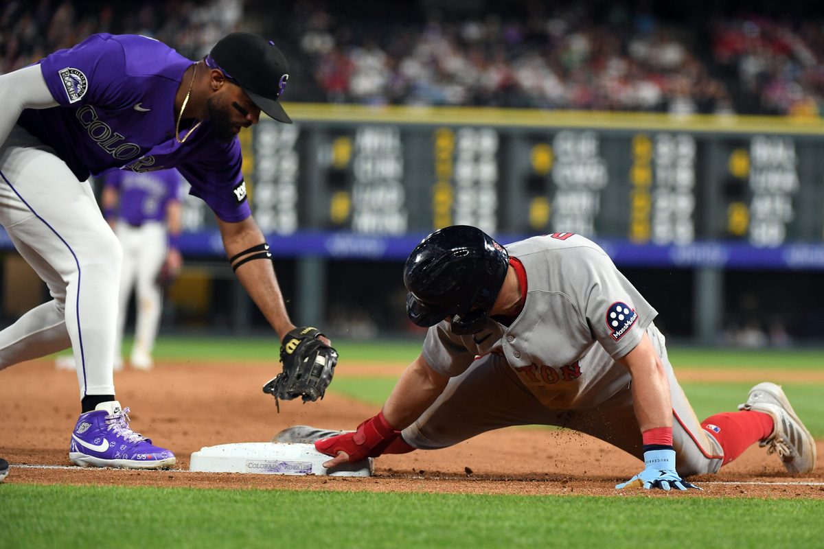 Jun 22, 2026; Denver, Colorado, USA; Boston Red Sox infielder Caleb Durbin (5) slides safely into third base ahead of a tag by Colorado Rockies outfielder Willi Castro (3) in the ninth inning at Coors Field. Mandatory Credit: Christopher Hanewinckel-Imagn Images