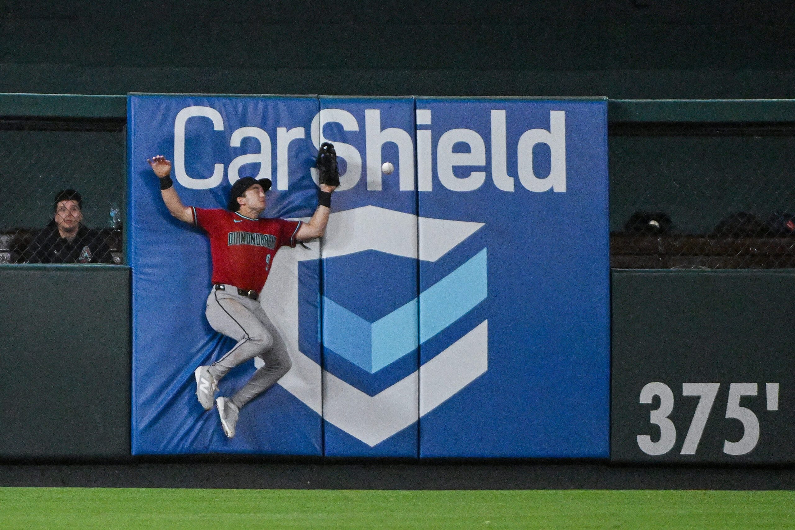Jun 23, 2026; St. Louis, Missouri, USA; Arizona Diamondbacks left fielder Tommy Troy (9) leaps at the wall but is unable to catch a double hit by St. Louis Cardinals center fielder Lars Nootbaar (not pictured) during the ninth inning at Busch Stadium. Mandatory Credit: Jeff Curry-Imagn Images