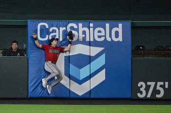 Jun 23, 2026; St. Louis, Missouri, USA; Arizona Diamondbacks left fielder Tommy Troy (9) leaps at the wall but is unable to catch a double hit by St. Louis Cardinals center fielder Lars Nootbaar (not pictured) during the ninth inning at Busch Stadium. Mandatory Credit: Jeff Curry-Imagn Images