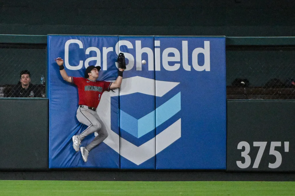 Jun 23, 2026; St. Louis, Missouri, USA; Arizona Diamondbacks left fielder Tommy Troy (9) leaps at the wall but is unable to catch a double hit by St. Louis Cardinals center fielder Lars Nootbaar (not pictured) during the ninth inning at Busch Stadium. Mandatory Credit: Jeff Curry-Imagn Images