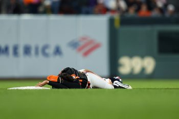 Jun 23, 2026; San Francisco, California, USA; San Francisco Giants right fielder Jung Hoo Lee (51) lays on the ground after colliding with Athletics second baseman Jeff McNeil (22) at second base during the sixth inning at Oracle Park. Mandatory Credit: Sergio Estrada-Imagn Images