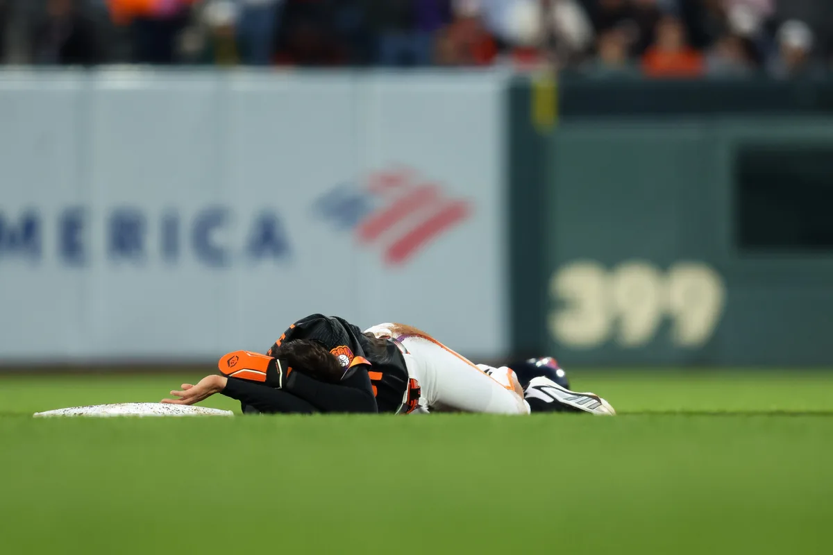 Jun 23, 2026; San Francisco, California, USA; San Francisco Giants right fielder Jung Hoo Lee (51) lays on the ground after colliding with Athletics second baseman Jeff McNeil (22) at second base during the sixth inning at Oracle Park. Mandatory Credit: Sergio Estrada-Imagn Images