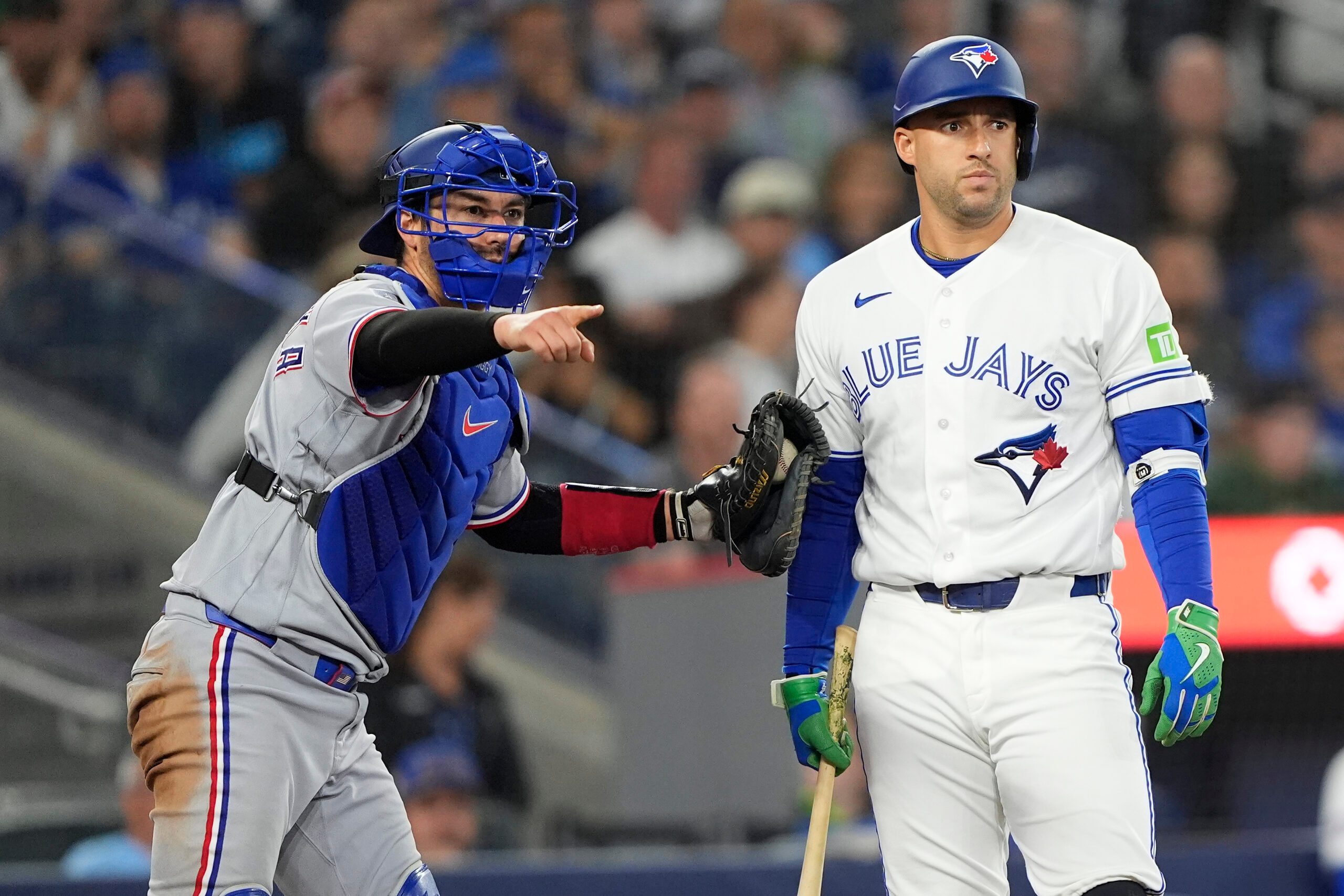 Jun 25, 2026; Toronto, Ontario, CAN; Texas Rangers catcher Kyle Higashioka (11) loks for a strike call against Toronto Blue Jays designated hitter George Springer (4) during the eighth inning at Rogers Centre. Mandatory Credit: John E. Sokolowski-Imagn Images