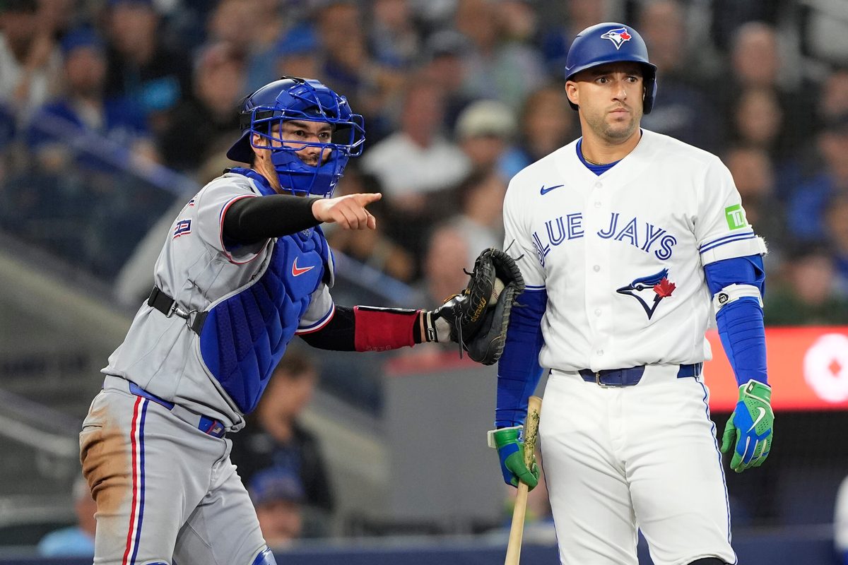 Jun 25, 2026; Toronto, Ontario, CAN; Texas Rangers catcher Kyle Higashioka (11) loks for a strike call against Toronto Blue Jays designated hitter George Springer (4) during the eighth inning at Rogers Centre. Mandatory Credit: John E. Sokolowski-Imagn Images