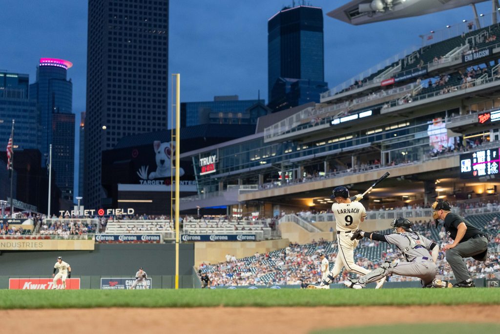 Jun 27, 2026; Minneapolis, Minnesota, USA; Minnesota Twins left fielder Trevor Larnach (9) hits double, scoring three runs in the ninth inning against the Colorado Rockies at Target Field. Mandatory Credit: Matt Blewett-Imagn Images