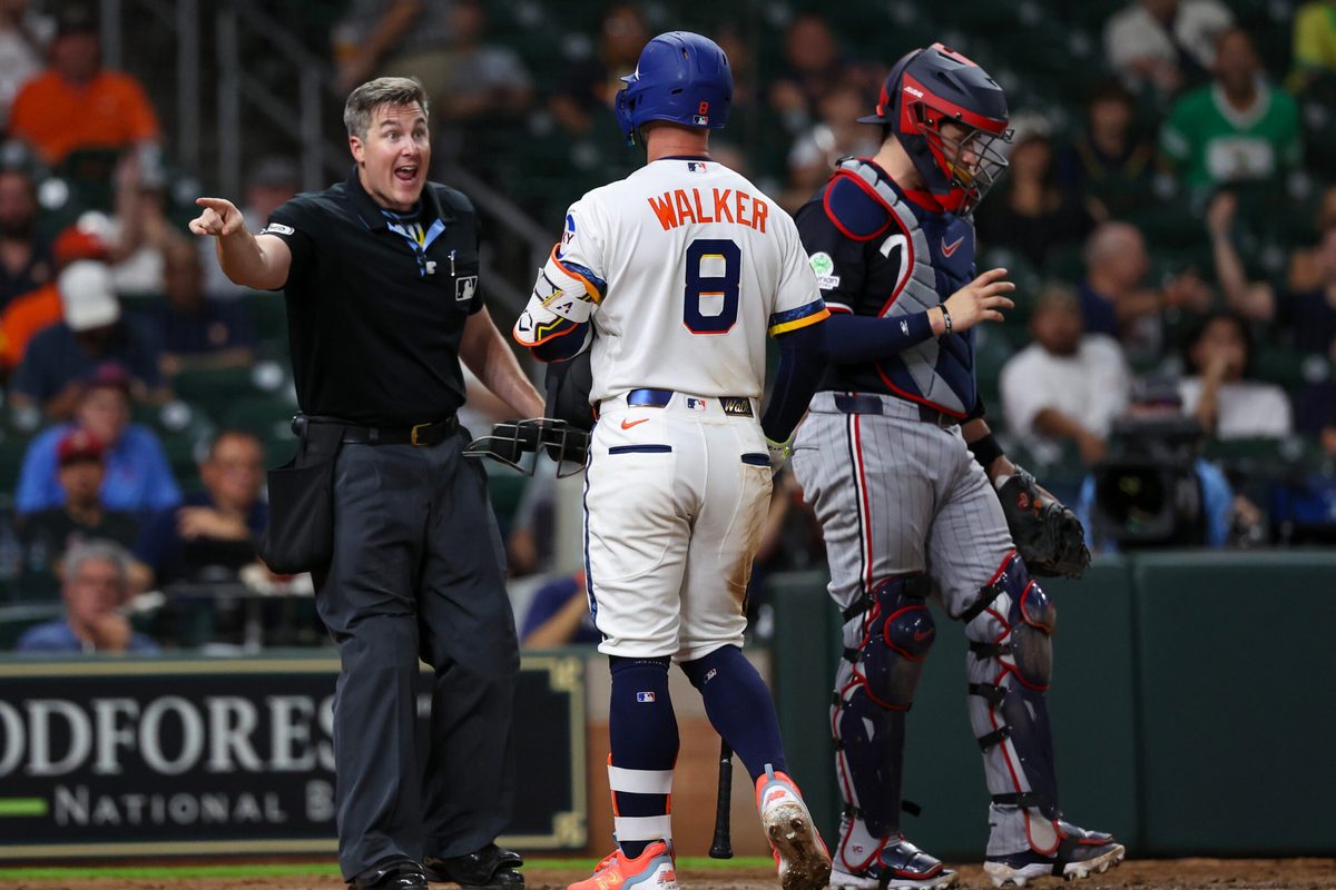 Jun 29, 2026; Houston, Texas, USA; Houston Astros first baseman Christian Walker (8) argues with umpire Brennan Miller (55) after being called out on strikes against the Minnesota Twins in the ninth inning at Daikin Park. Mandatory Credit: Thomas Shea-Imagn Images