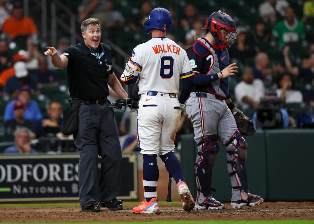 Jun 29, 2026; Houston, Texas, USA; Houston Astros first baseman Christian Walker (8) argues with umpire Brennan Miller (55) after being called out on strikes against the Minnesota Twins in the ninth inning at Daikin Park. Mandatory Credit: Thomas Shea-Imagn Images