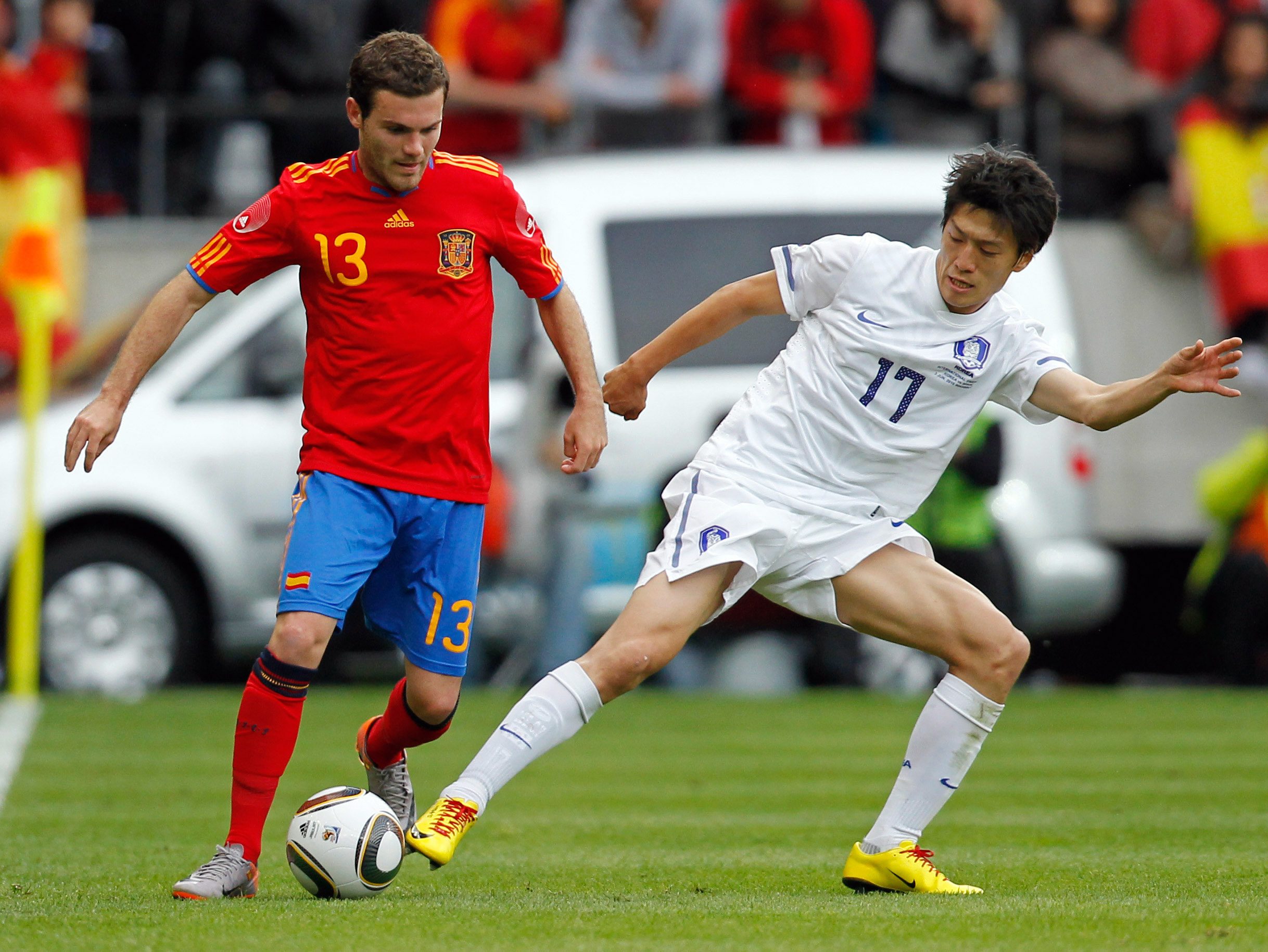 June 3, 2010; Innsbruck, AUSTRIA; Spain midfielder Juan Mata (13) battles for the ball with South Korea midfielder Lee Chung-Yong (17) during an international friendly in Innsbruck.  Mandatory Credit: Amir Beganovic/GEPA via Imagn Images