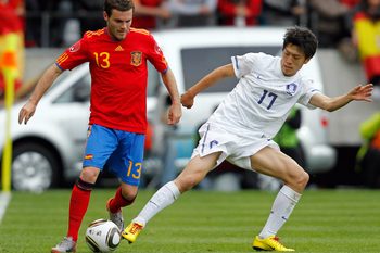 June 3, 2010; Innsbruck, AUSTRIA; Spain midfielder Juan Mata (13) battles for the ball with South Korea midfielder Lee Chung-Yong (17) during an international friendly in Innsbruck.  Mandatory Credit: Amir Beganovic/GEPA via Imagn Images