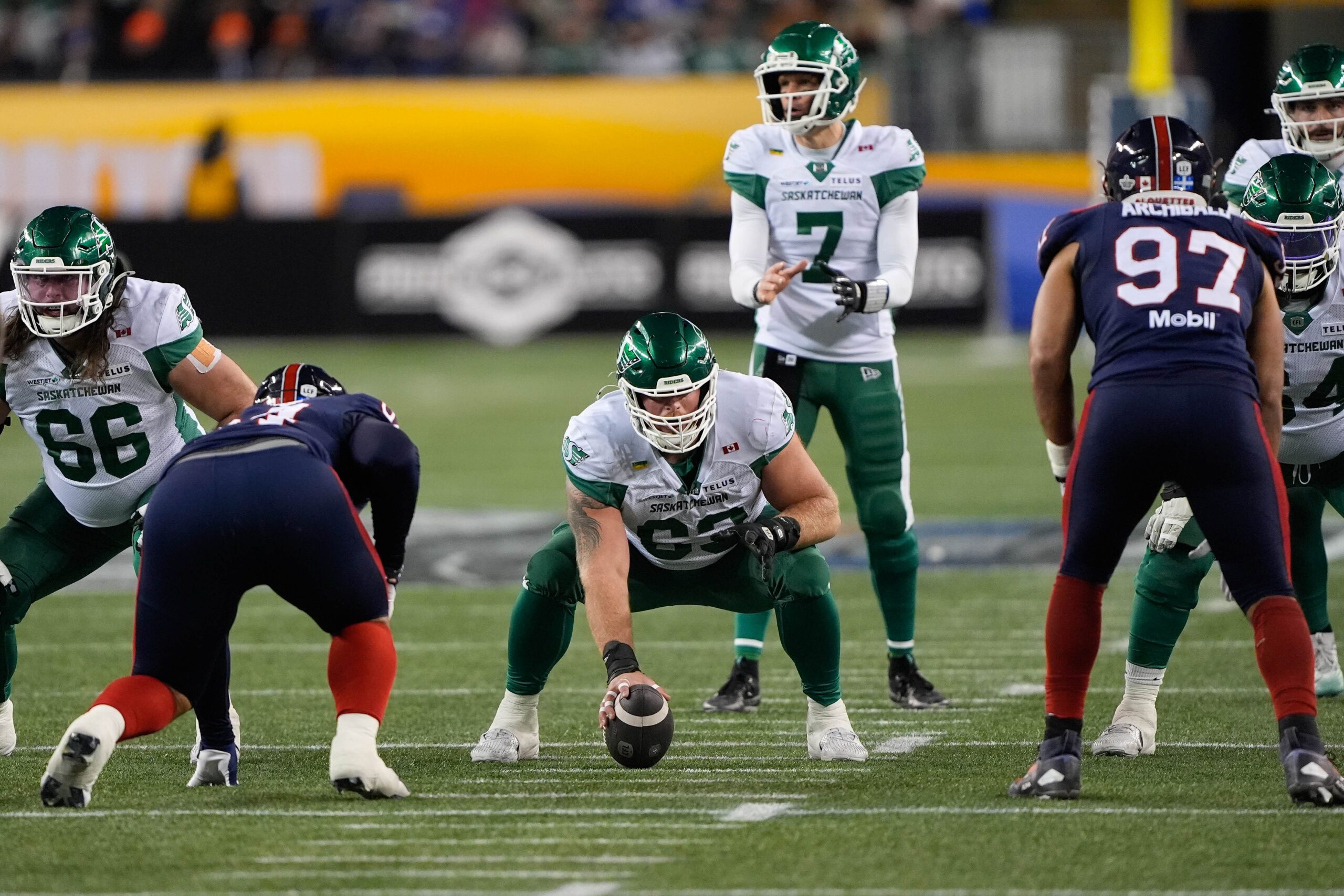 Nov 16, 2025; Winnipeg, Manitoba, Canada; Saskatchewan Roughriders center Logan Ferland (63) goes to snap the ball to quarterback Trevor Harris (7) during the 112th Grey Cup Championship against the Montreal Alouettes at Princess Auto Stadium. Mandatory Credit: John E. Sokolowski-Imagn Images